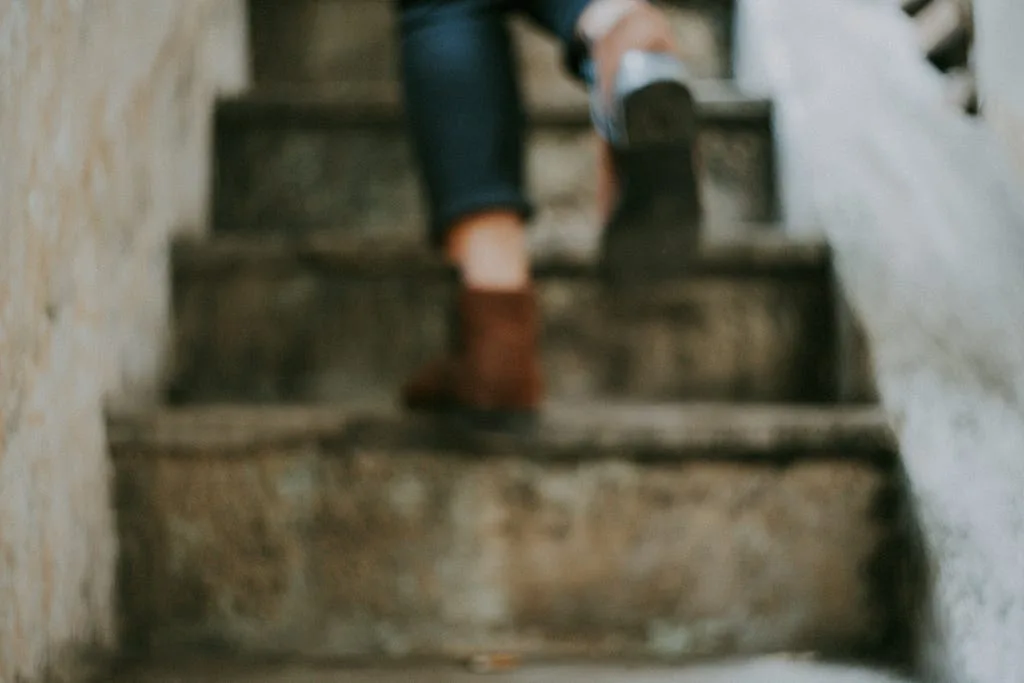A person climbing a stone staircase